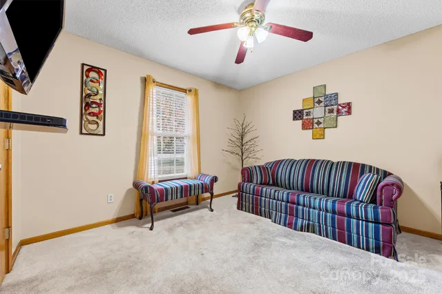 a bedroom with furniture and a large window