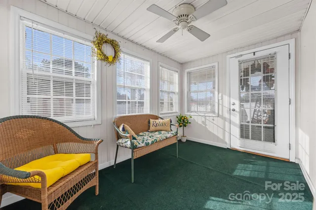 a living room with furniture and a floor to ceiling window
