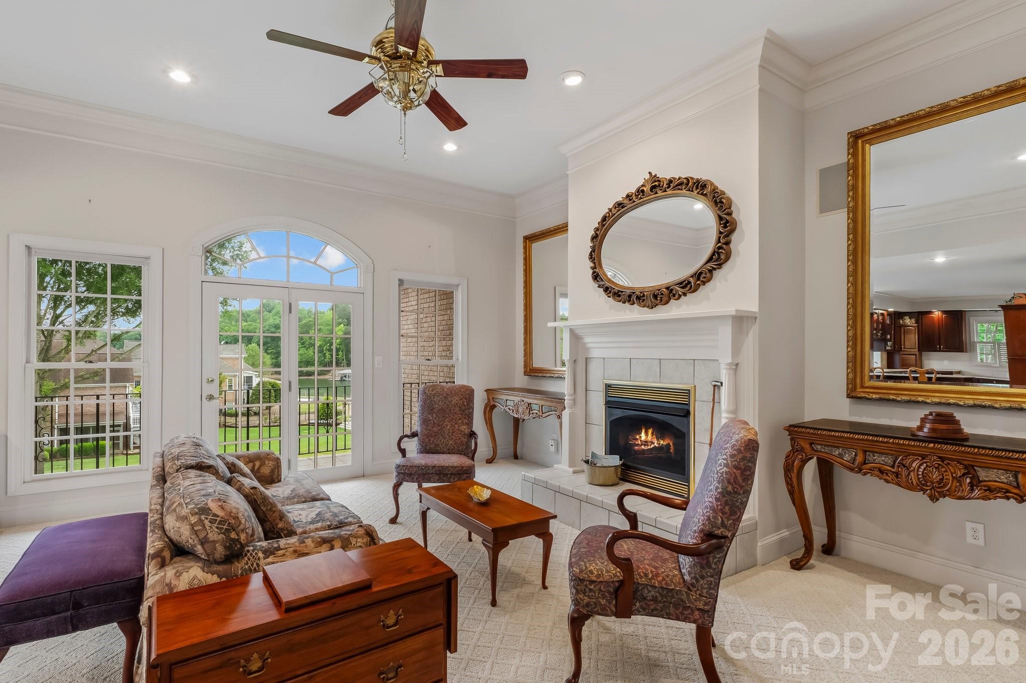 221 Windemere Isle Road Statesville, NC 28677 - Photo 12 of 42 a living room with furniture a fireplace and a large window