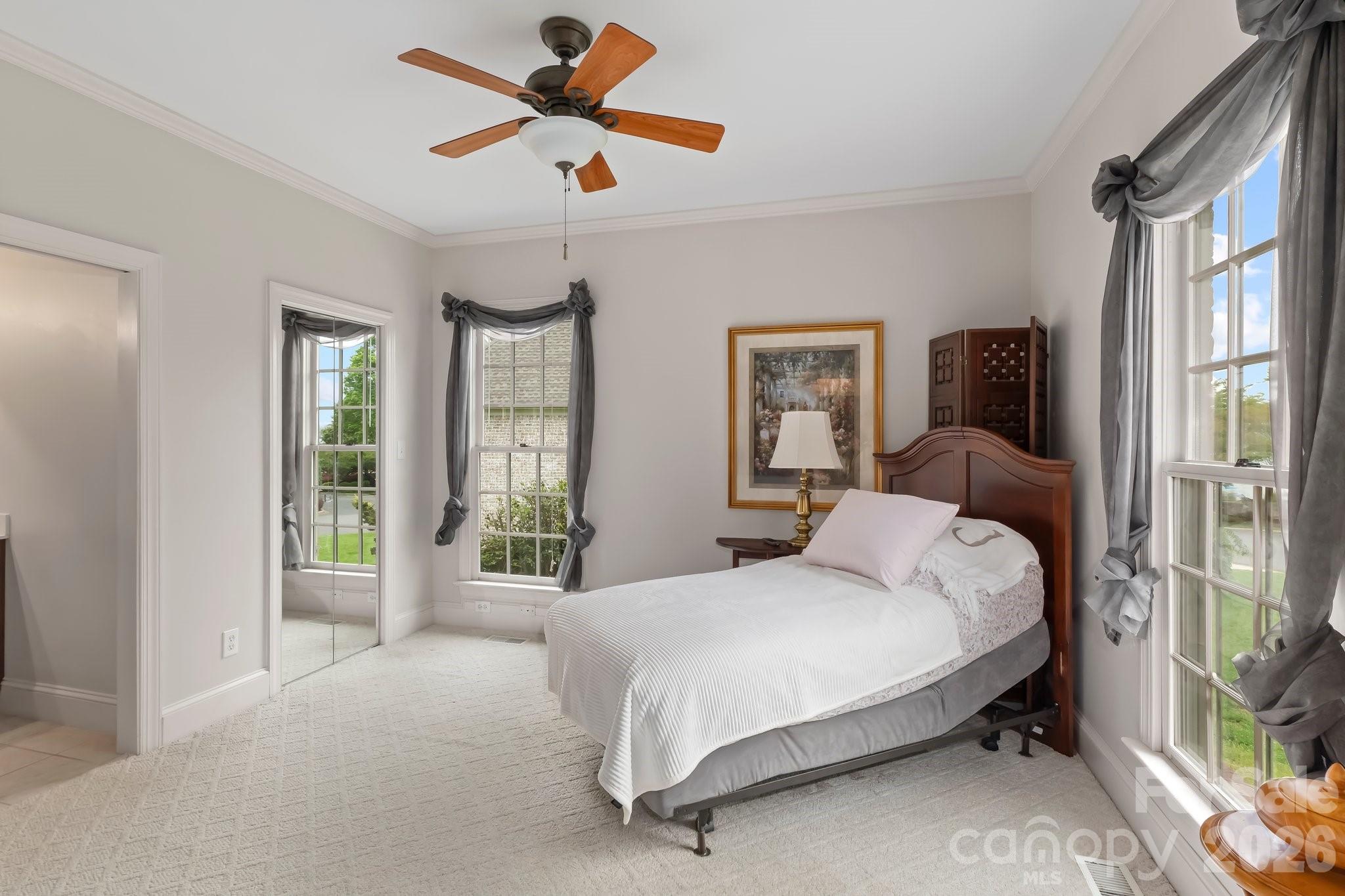 221 Windemere Isle Road Statesville, NC 28677 - Photo 18 of 42 a bedroom with a large bed and a large window