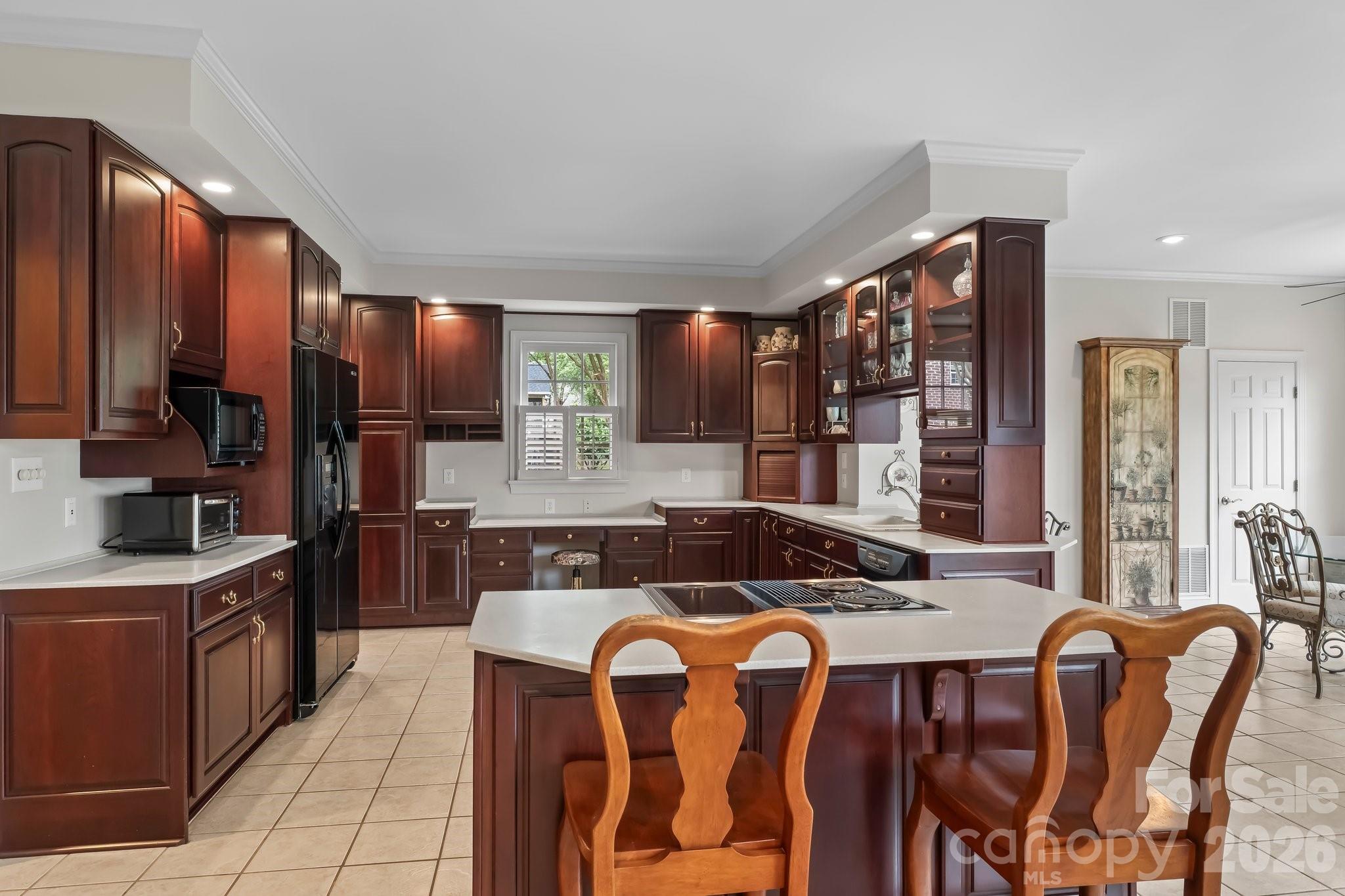 221 Windemere Isle Road Statesville, NC 28677 - Photo 8 of 42 a kitchen with stainless steel appliances granite countertop a sink a stove a refrigerator cabinets and chairs