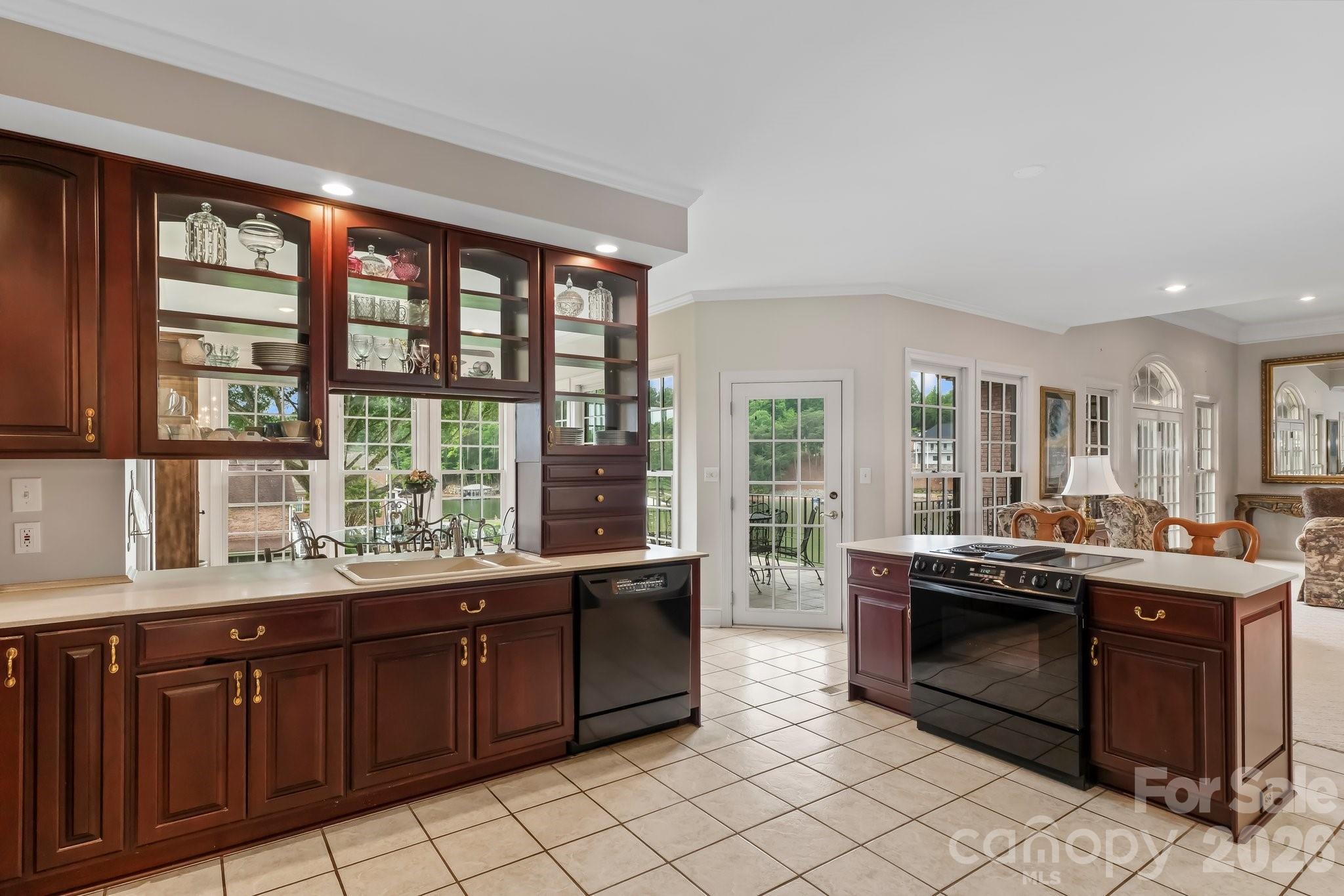 221 Windemere Isle Road Statesville, NC 28677 - Photo 10 of 42 a room with kitchen island granite countertop a sink and a large window