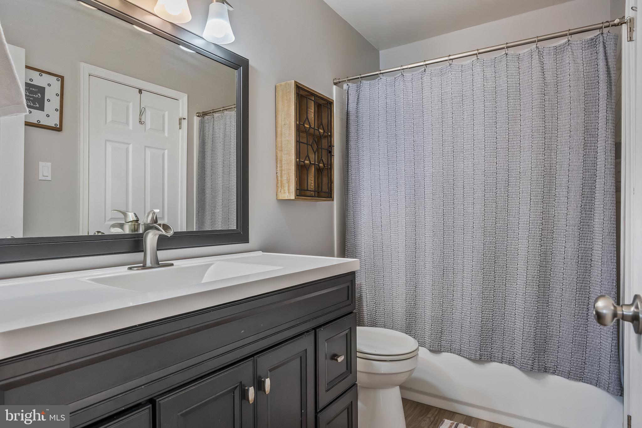 51 Blue Spruce Court Lumberton, NJ 08048 - Photo 11 of 28 a bathroom with a sink a toilet a mirror and shower curtain