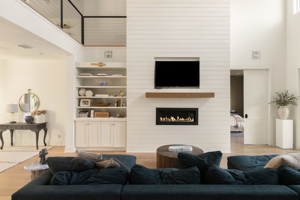 32045 Mirela Ann Road Dripping Springs, TX 78620 - Photo 11 of 30 Sunlight fills the soaring living space anchored by a modern fireplace wall and custom built-ins.