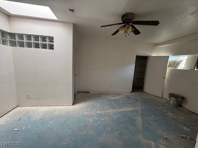 1275 Westwind Road Las Vegas, NV 89146 - Photo 4 of 30 Unfurnished bedroom with a skylight, ceiling fan, and a textured ceiling