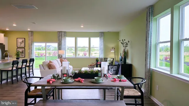 a living room with furniture and floor to ceiling windows