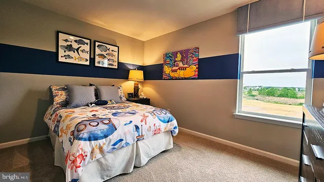 a bedroom with a bed and a painting on the wall