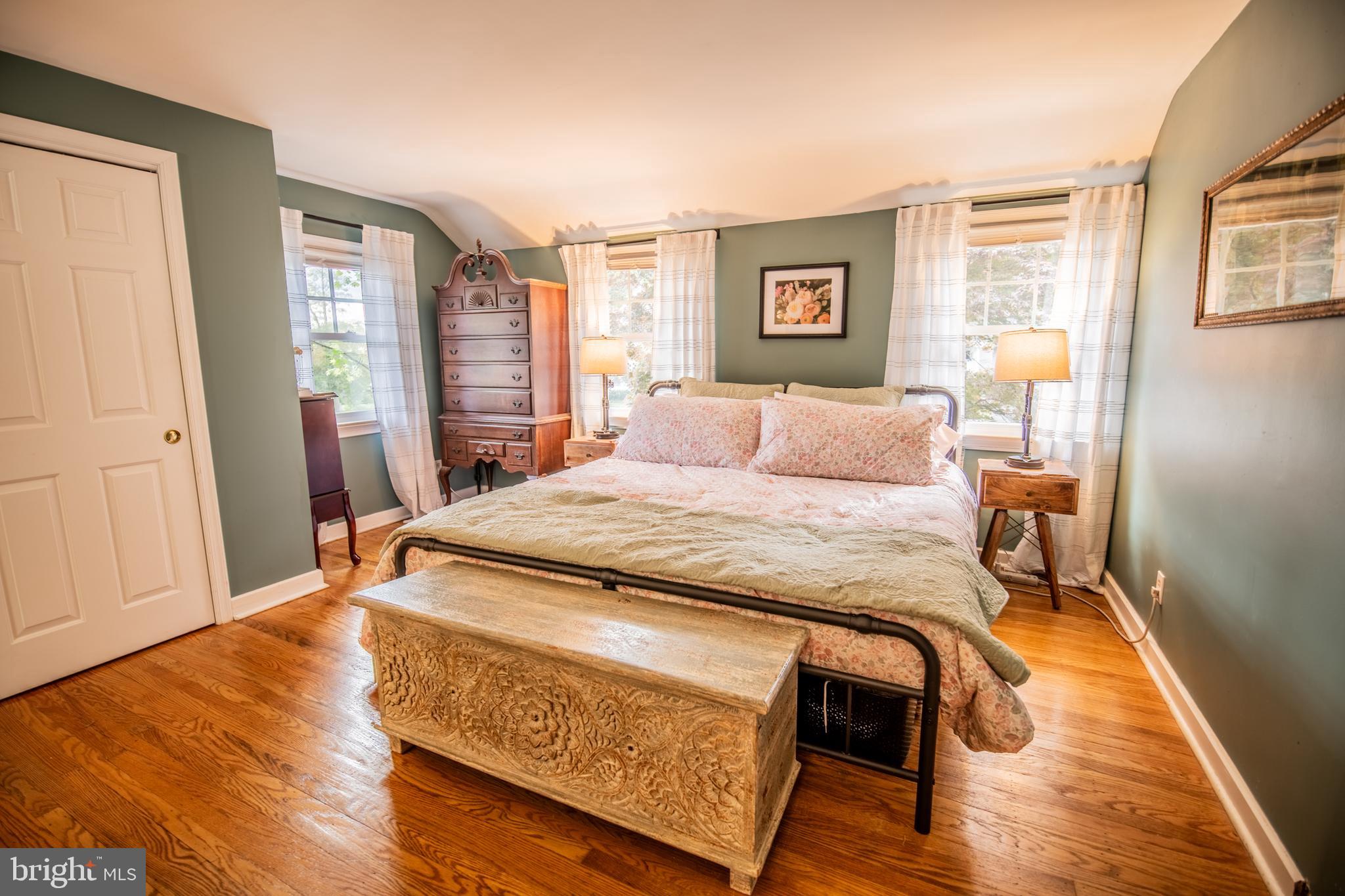 141 Cascade Road Springfield, PA 19064 - Photo 14 of 29 a bedroom with a bed and wooden floor