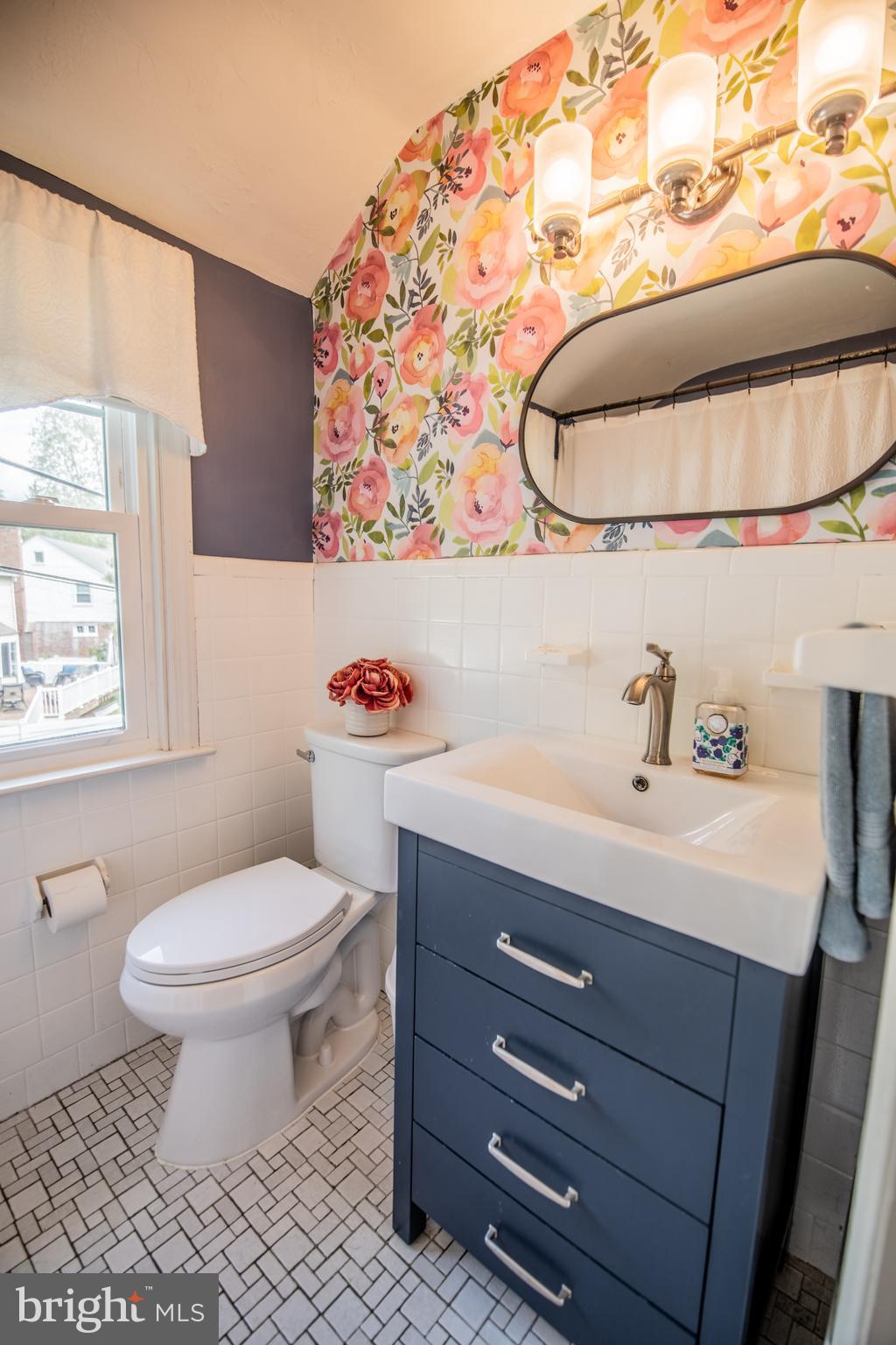 141 Cascade Road Springfield, PA 19064 - Photo 21 of 29 a bathroom with a sink and a mirror