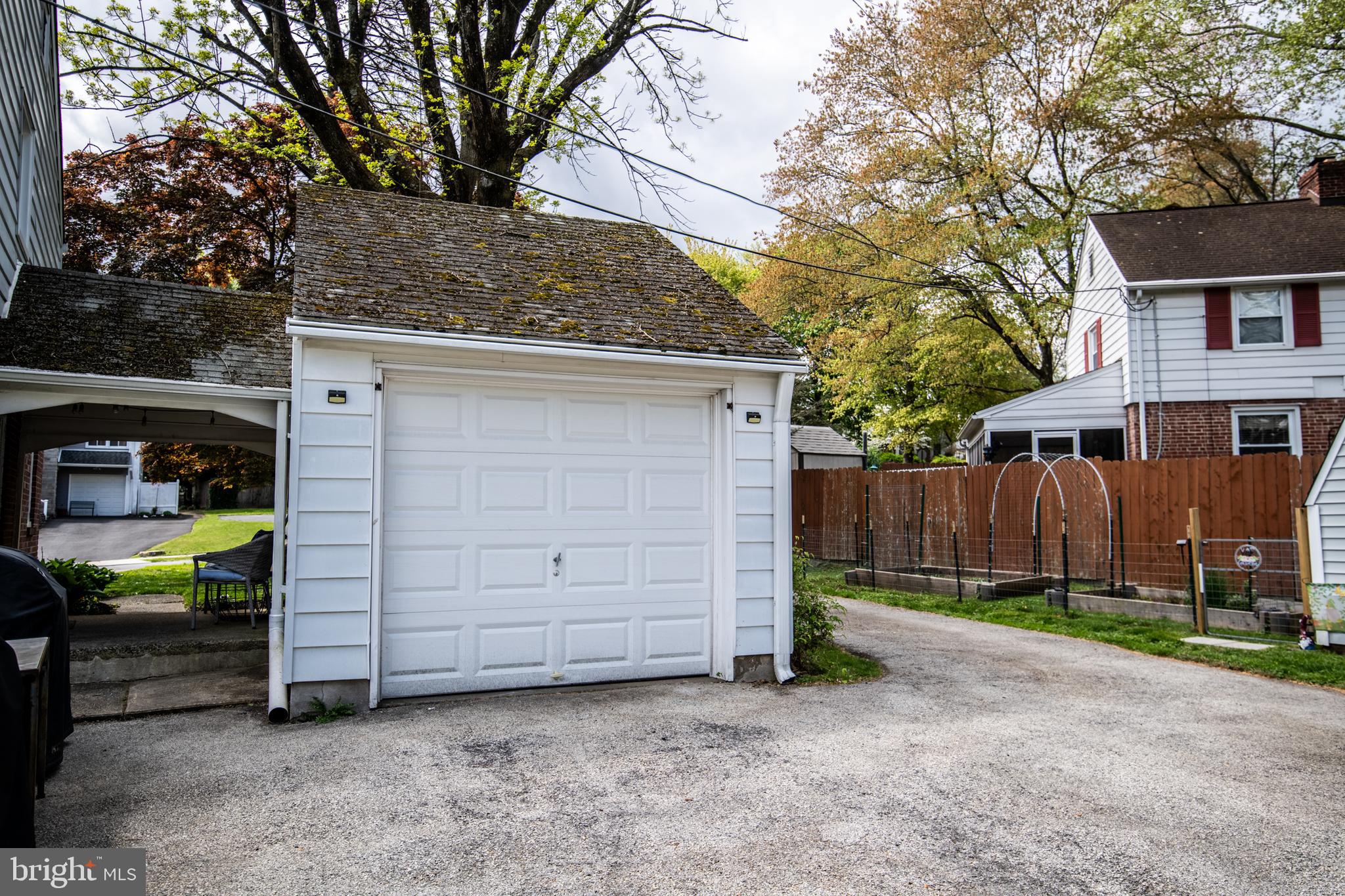 141 Cascade Road Springfield, PA 19064 - Photo 26 of 29 a view of a house with a small yard and wooden fence