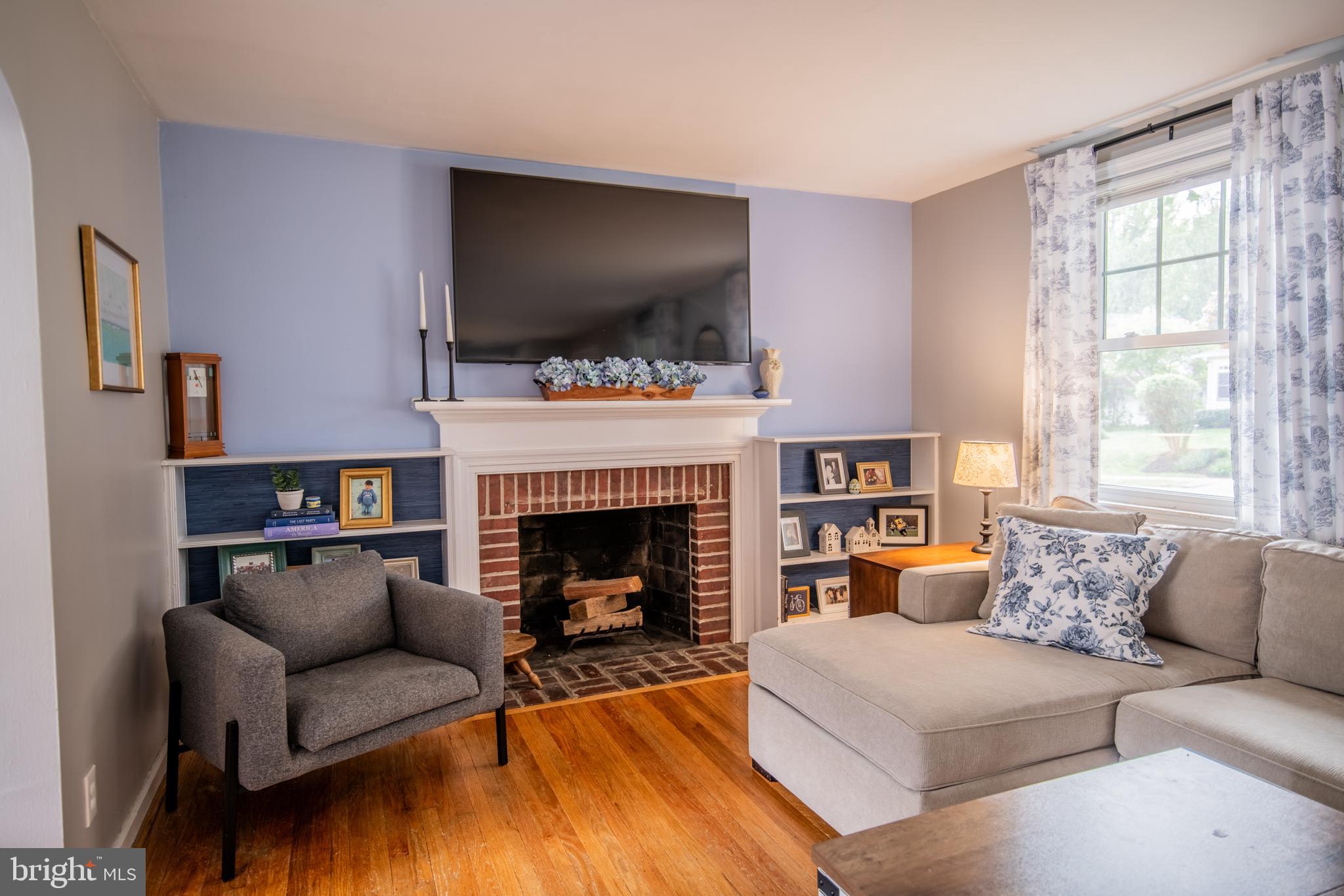 141 Cascade Road Springfield, PA 19064 - Photo 6 of 29 a living room with furniture a flat screen tv and a fireplace