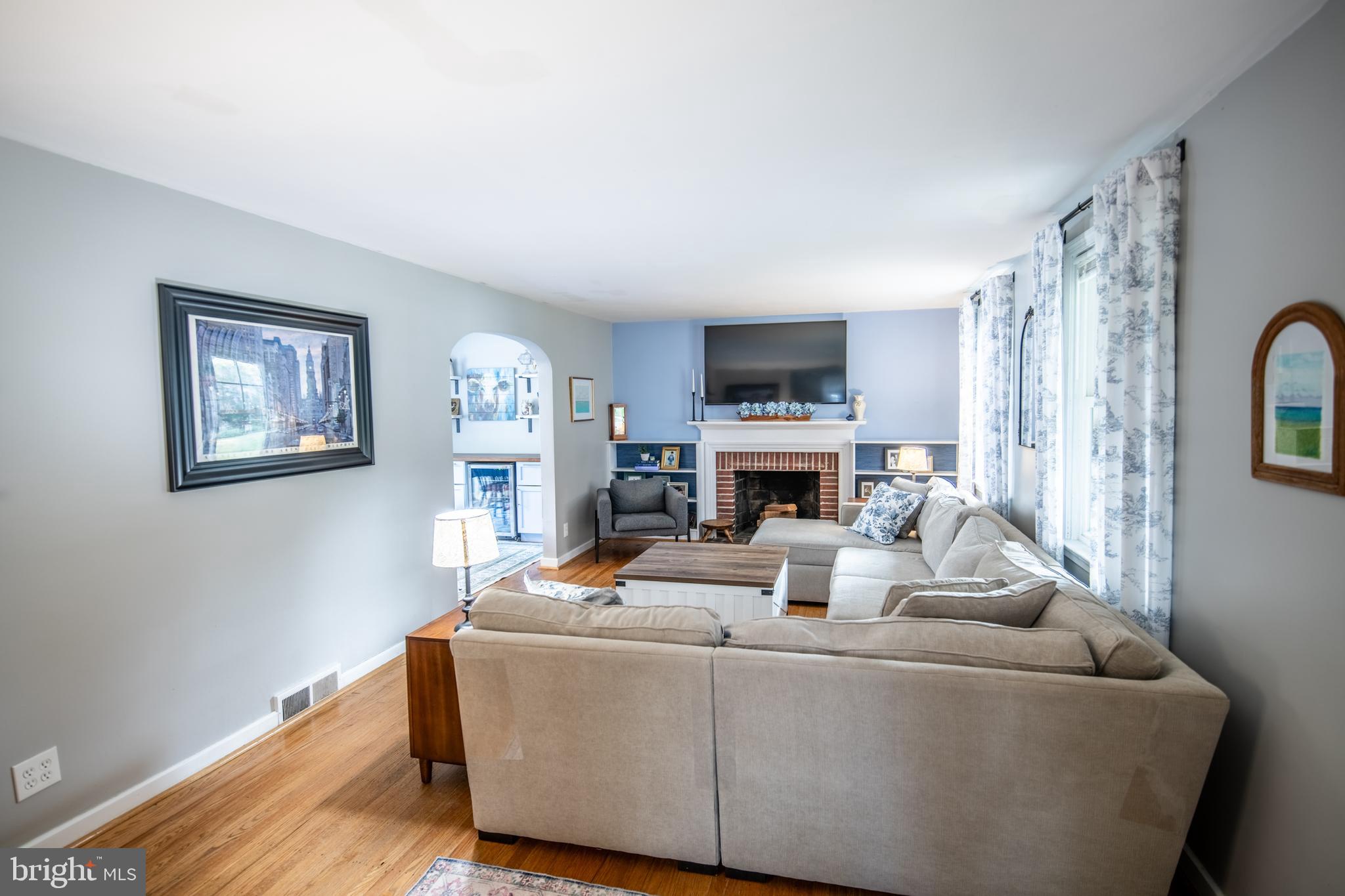 141 Cascade Road Springfield, PA 19064 - Photo 7 of 29 a living room with furniture a fireplace and a flat screen tv