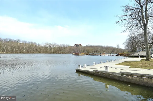 swimming pool view with a lake view