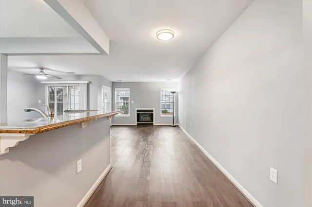a view of a livingroom with wooden floor and a sink