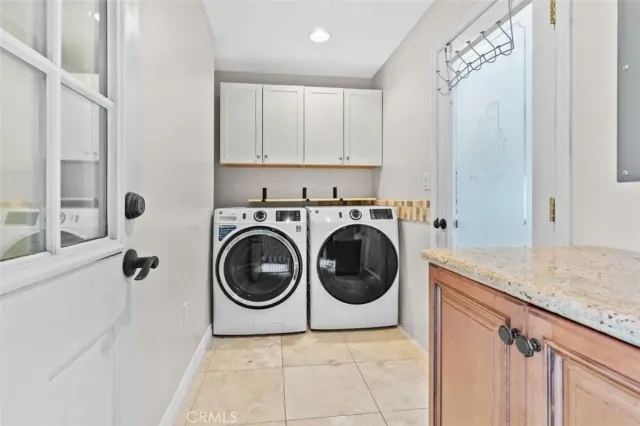 a utility room with sink dryer and washer