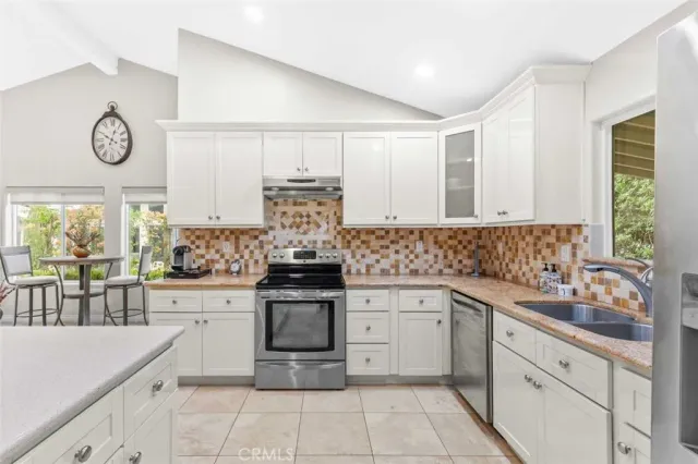 a kitchen with a stove top oven sink and cabinets