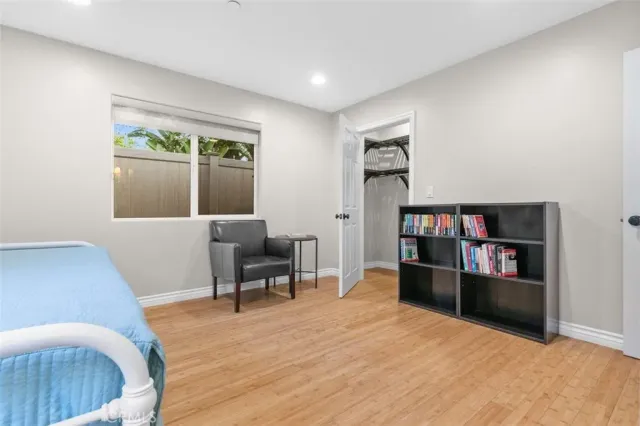 a living room with furniture and a book shelf