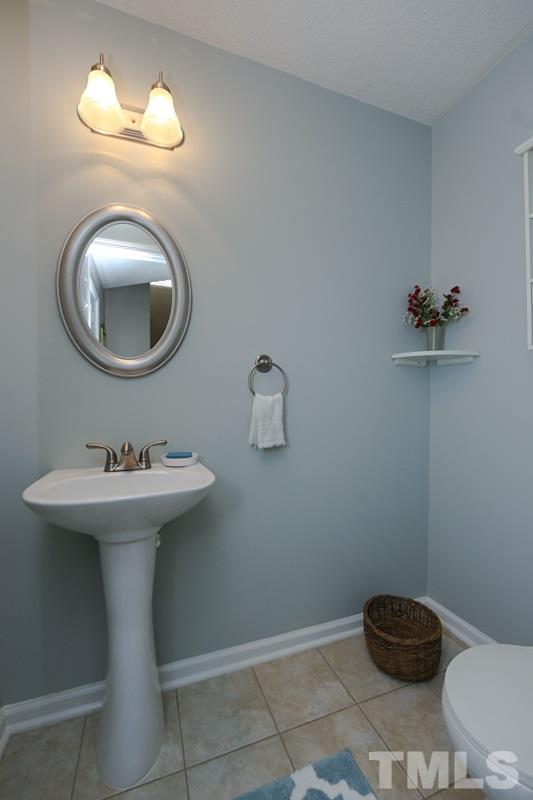 9112 Shallcross Way Raleigh, NC 27617 - Photo 10 of 16 a bathroom with a sink mirror and toilet