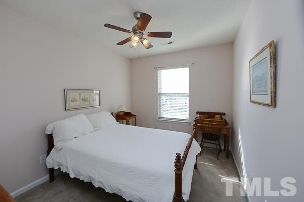 9112 Shallcross Way Raleigh, NC 27617 - Photo 11 of 16 a bedroom with a bed and a window
