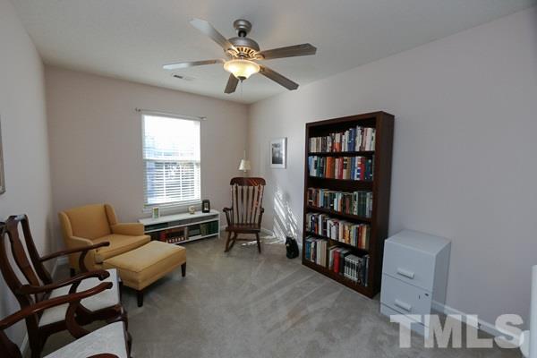 9112 Shallcross Way Raleigh, NC 27617 - Photo 12 of 16 a living room with furniture and a bookshelf