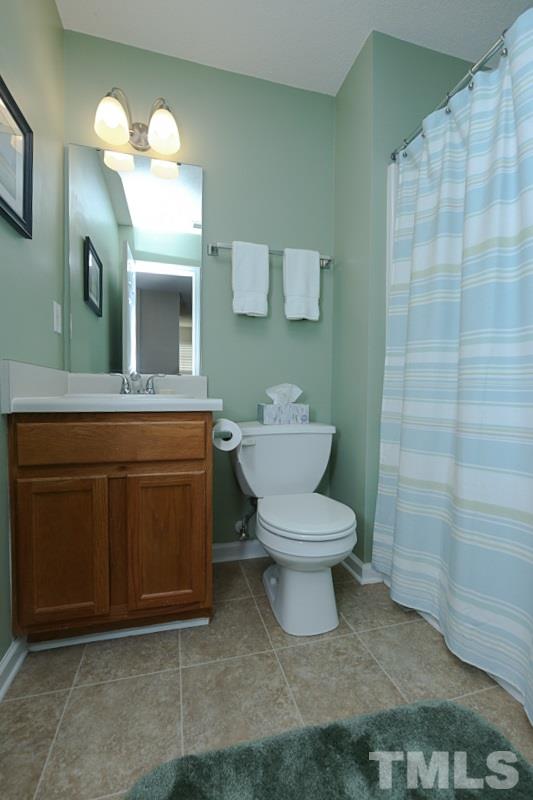 9112 Shallcross Way Raleigh, NC 27617 - Photo 13 of 16 a bathroom with a toilet sink and mirror