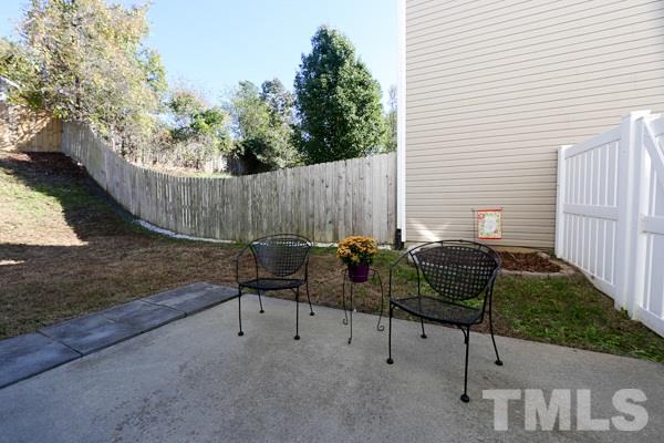 9112 Shallcross Way Raleigh, NC 27617 - Photo 14 of 16 a view of a chairs and table in the back yard of the house
