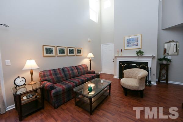 9112 Shallcross Way Raleigh, NC 27617 - Photo 3 of 16 a living room with furniture and a fireplace