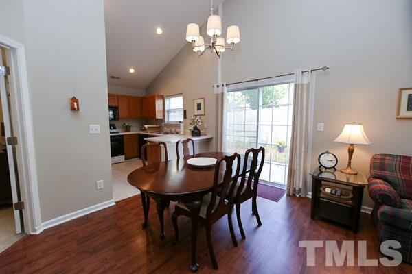 9112 Shallcross Way Raleigh, NC 27617 - Photo 5 of 16 a view of a dining room with furniture window and wooden floor