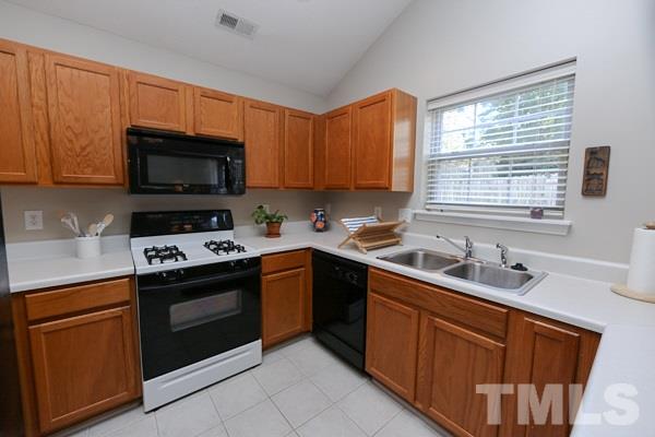 9112 Shallcross Way Raleigh, NC 27617 - Photo 7 of 16 a kitchen with stainless steel appliances a stove sink microwave and refrigerator