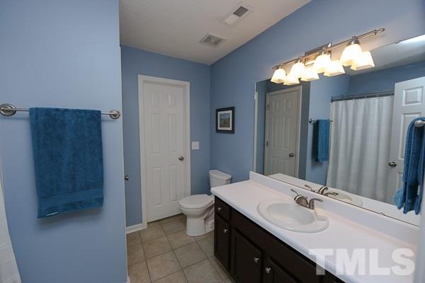 9112 Shallcross Way Raleigh, NC 27617 - Photo 9 of 16 a bathroom with a sink and a mirror