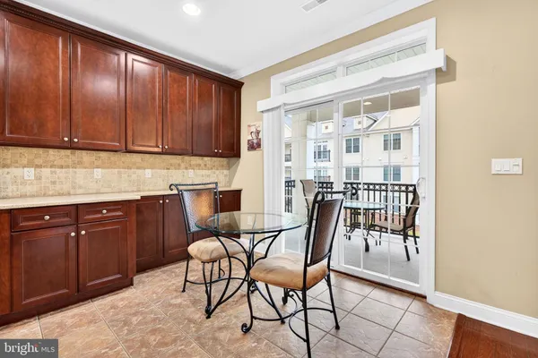 a kitchen with granite countertop wooden cabinets and stainless steel appliances