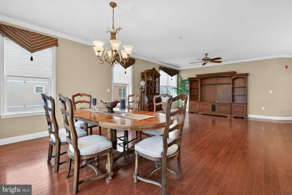 a view of a dining room with furniture wooden floor and chandelier