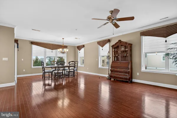 a view of dining room with furniture and wooden floor