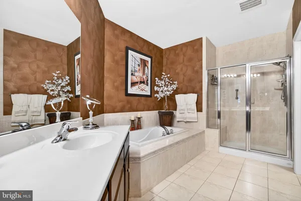 a bathroom with a sink mirror and a shower
