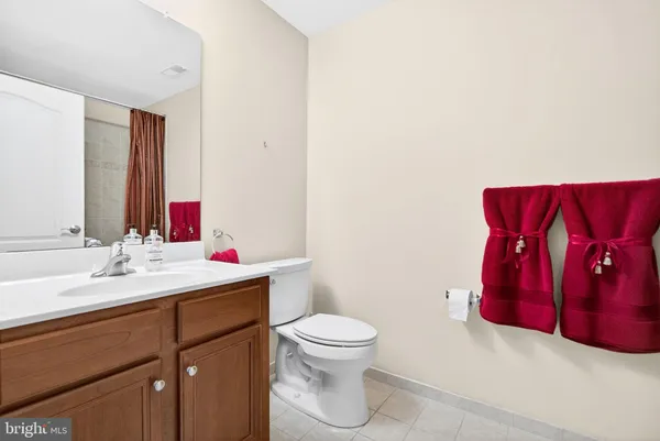 a bathroom with a sink vanity mirror and toilet