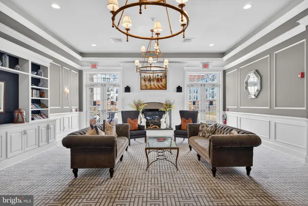 a living room with furniture a fireplace and a large window