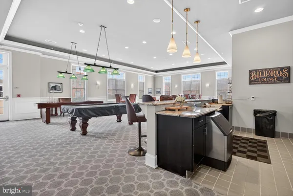 a living room with lots of furniture and kitchen view