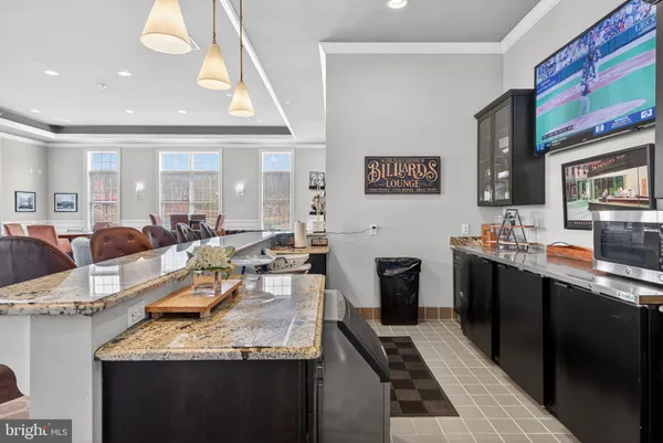 a large kitchen with stainless steel appliances granite countertop a lot of counter space and a sink
