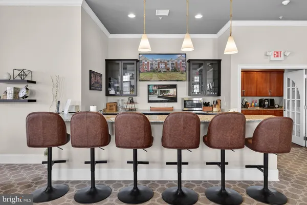 a kitchen with lots of chairs and refrigerator