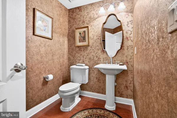 a bathroom with a toilet a sink and a mirror
