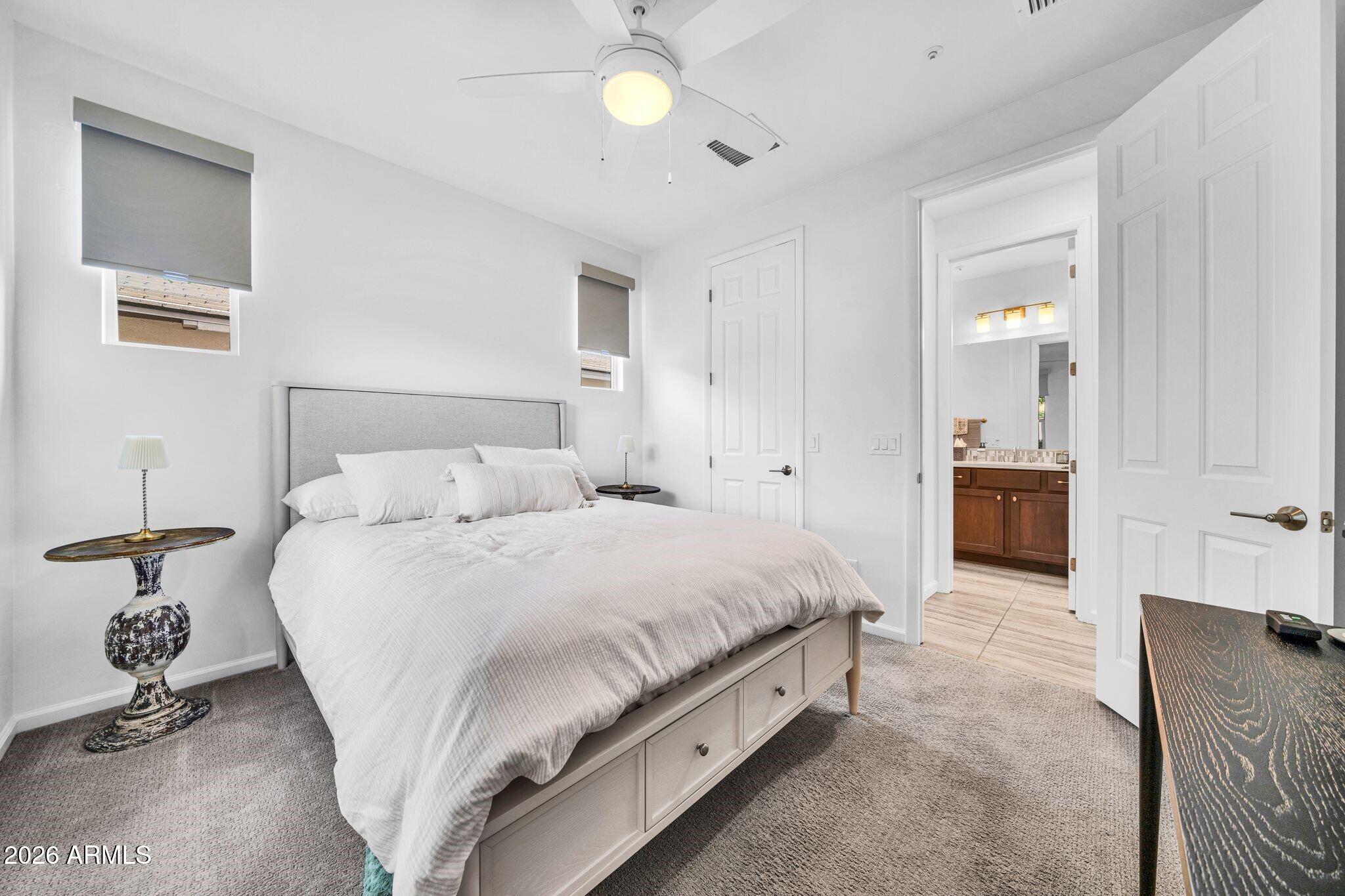 17983 East Vista Desierto Rio Verde, AZ 85263 - Photo 21 of 30 a bedroom with a bed and a chandelier