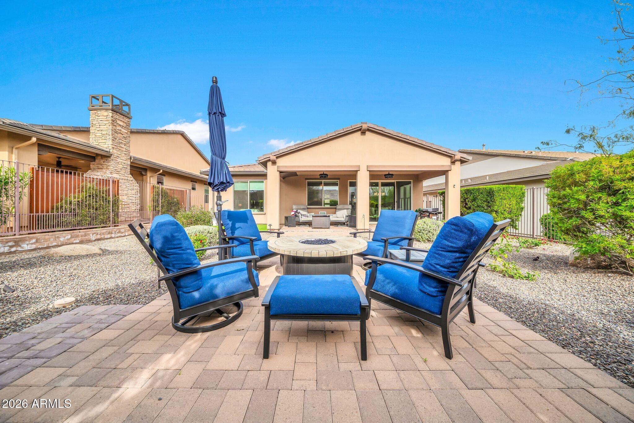 17983 East Vista Desierto Rio Verde, AZ 85263 - Photo 28 of 30 a view of a patio with table and chairs under an umbrella