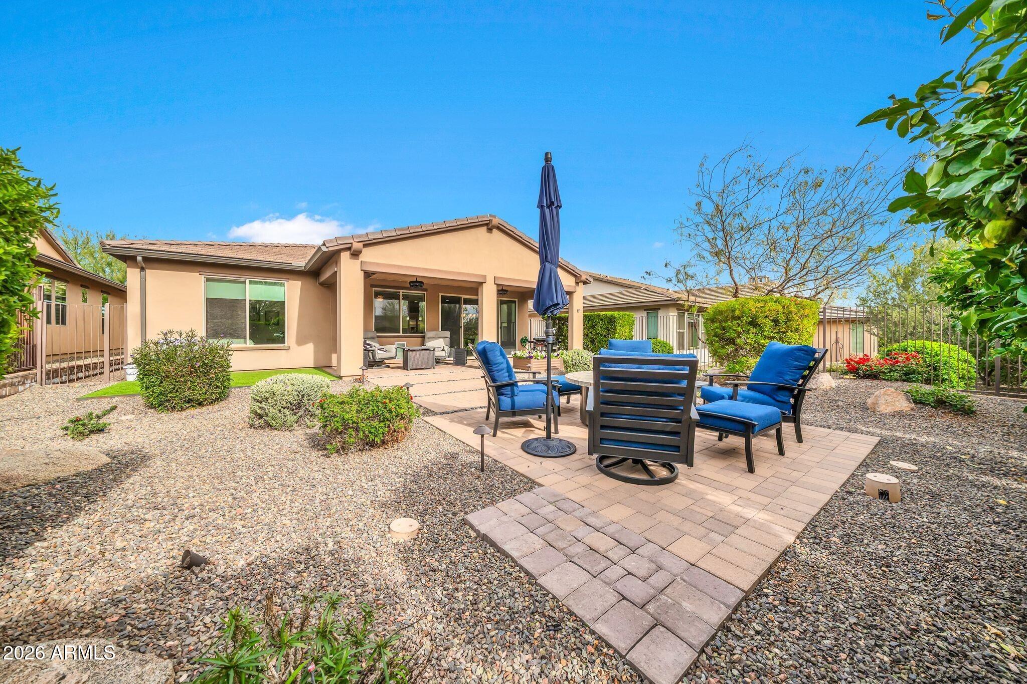 17983 East Vista Desierto Rio Verde, AZ 85263 - Photo 29 of 30 a view of a patio with a table and chairs under an umbrella