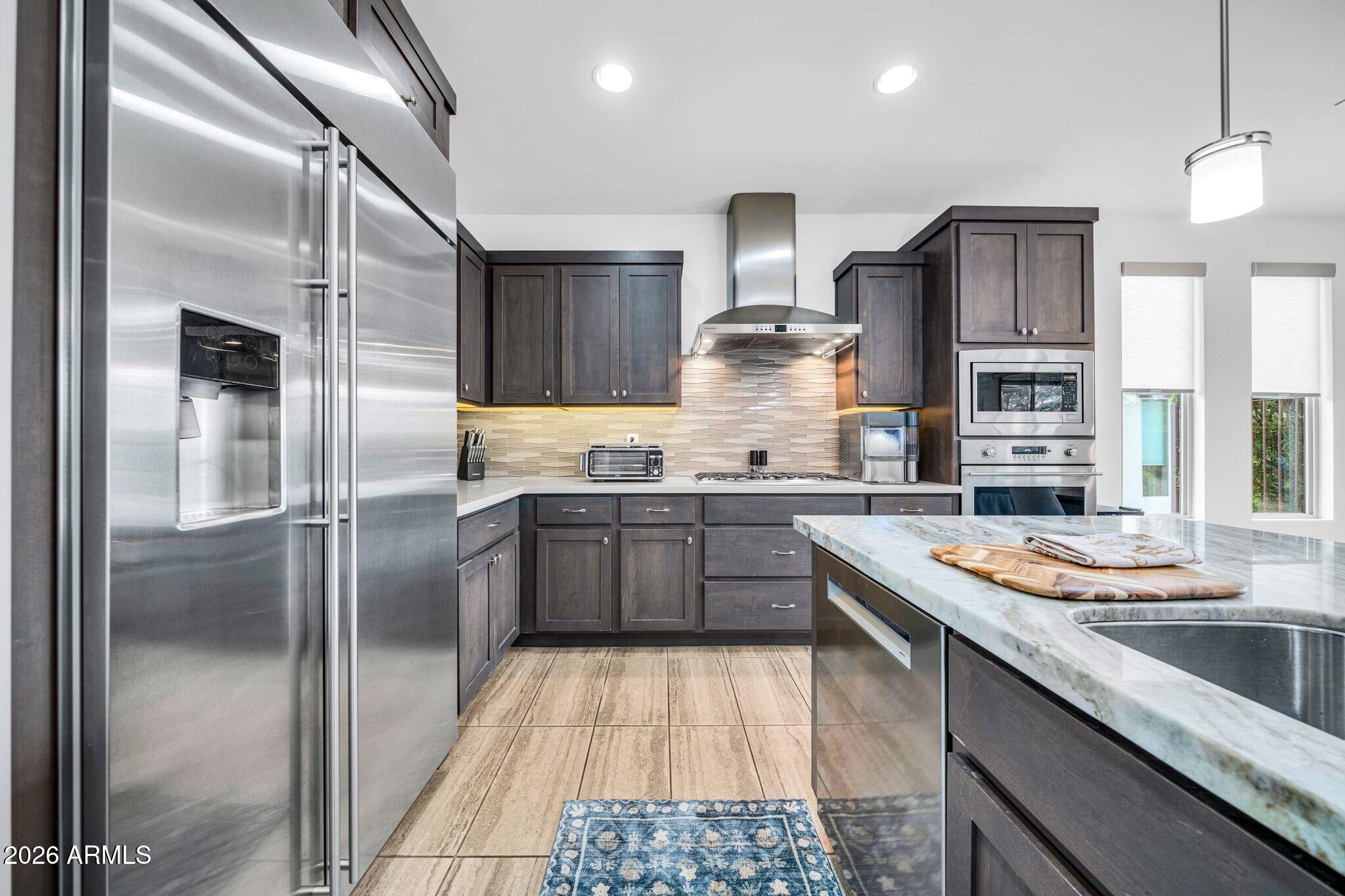 17983 East Vista Desierto Rio Verde, AZ 85263 - Photo 8 of 30 a kitchen with stainless steel appliances granite countertop a sink stove and refrigerator