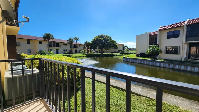 a view of swimming pool with outdoor seating and city view