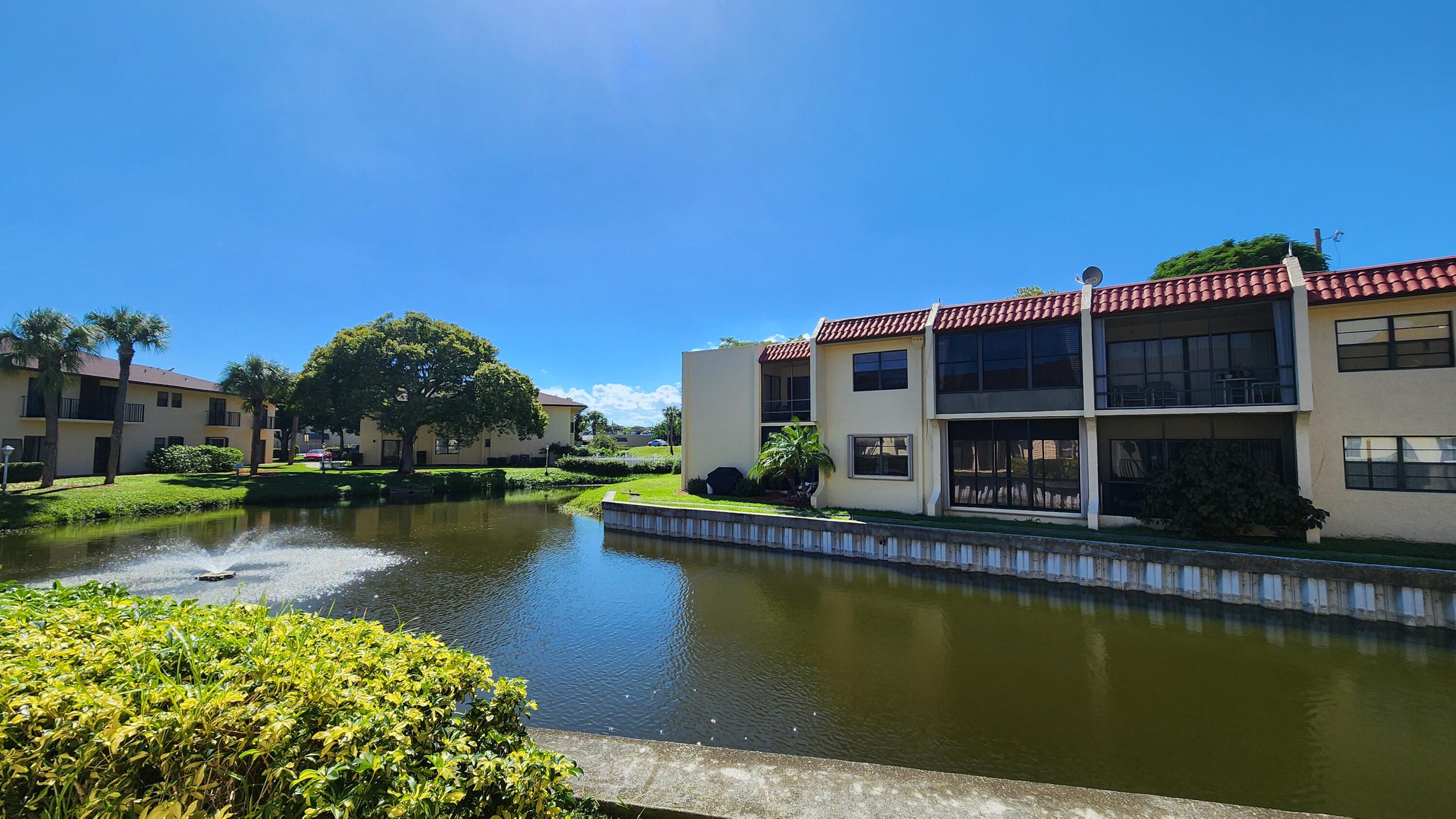 2050 Oleander Boulevard, Unit 9104 Fort Pierce, FL 34950 - Photo 22 of 27 a view of a swimming pool with a lake view