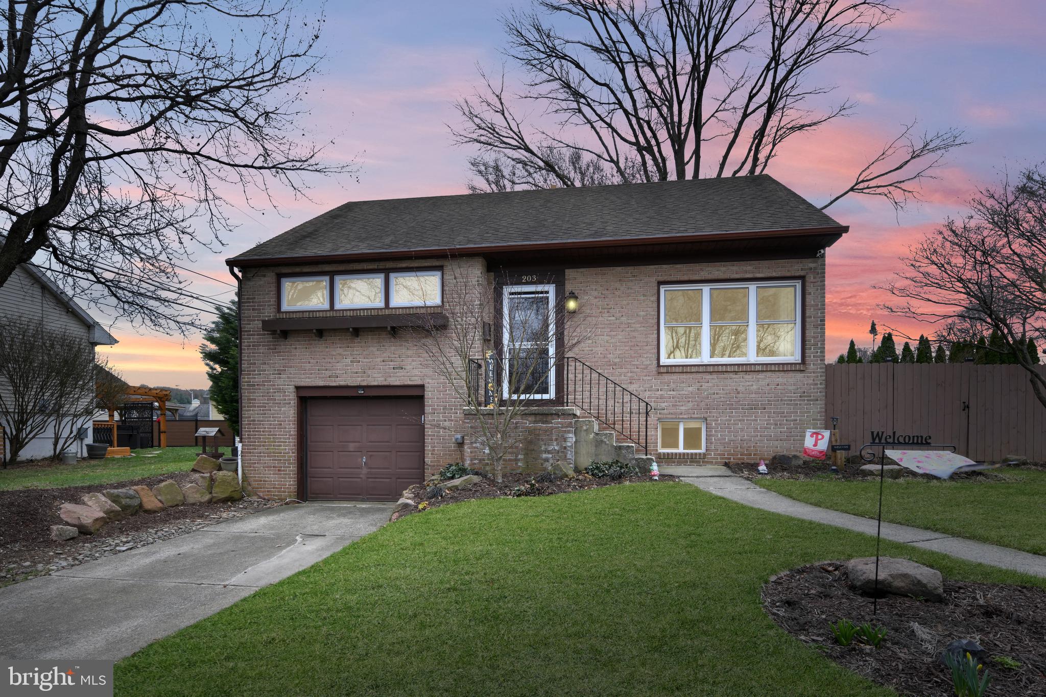 203 Eric Avenue Reading, PA 19607 - Photo 2 of 46 a front view of a house with a garden and yard