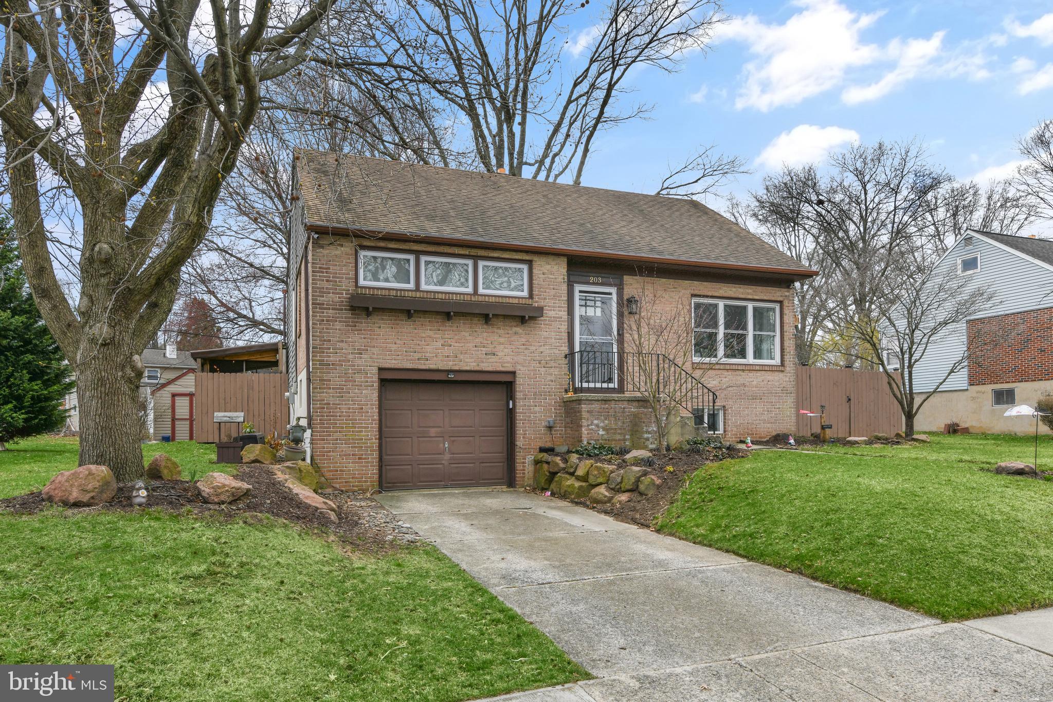 203 Eric Avenue Reading, PA 19607 - Photo 34 of 46 a front view of a house with a garden and yard