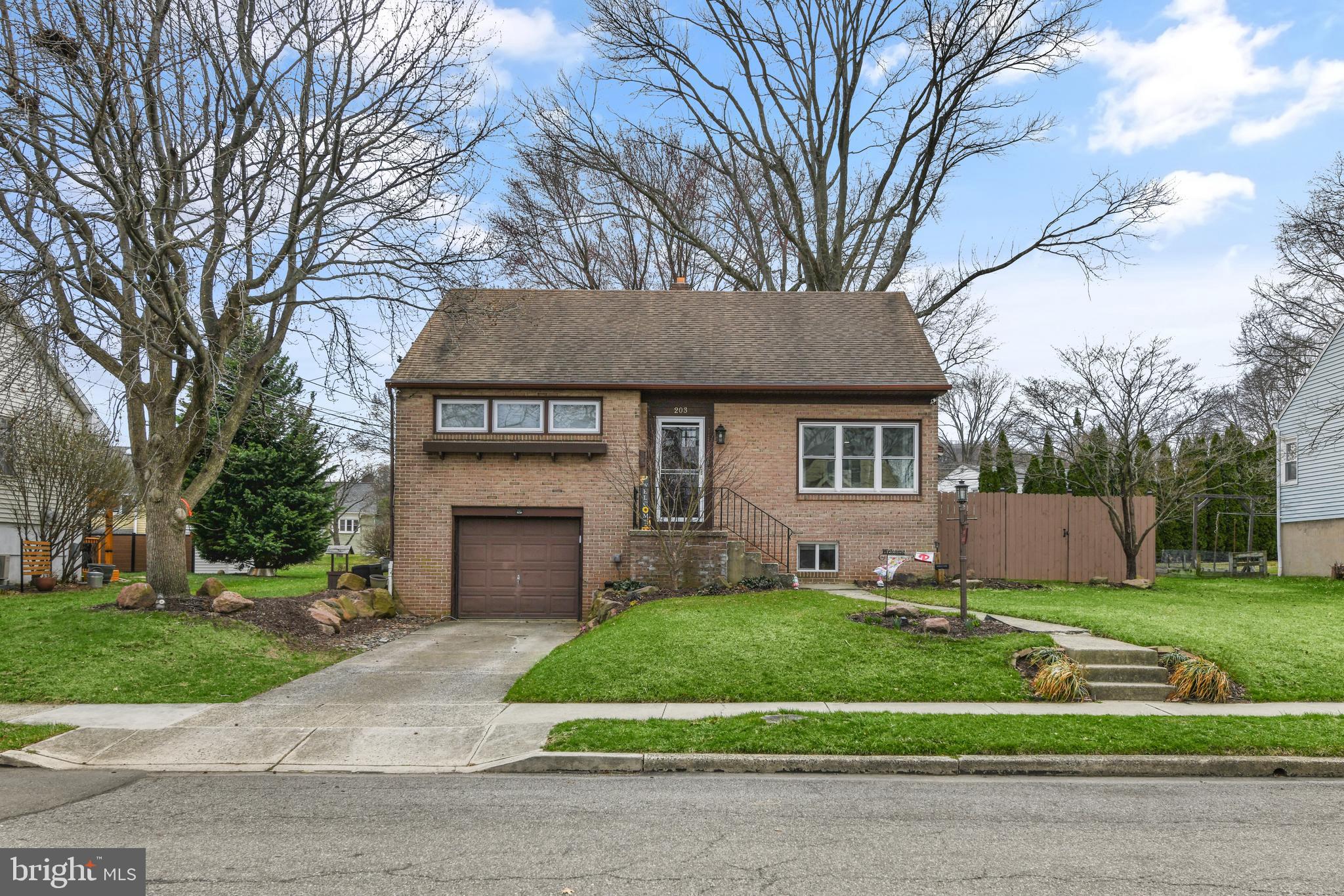 203 Eric Avenue Reading, PA 19607 - Photo 36 of 46 a front view of a house with a garden and trees
