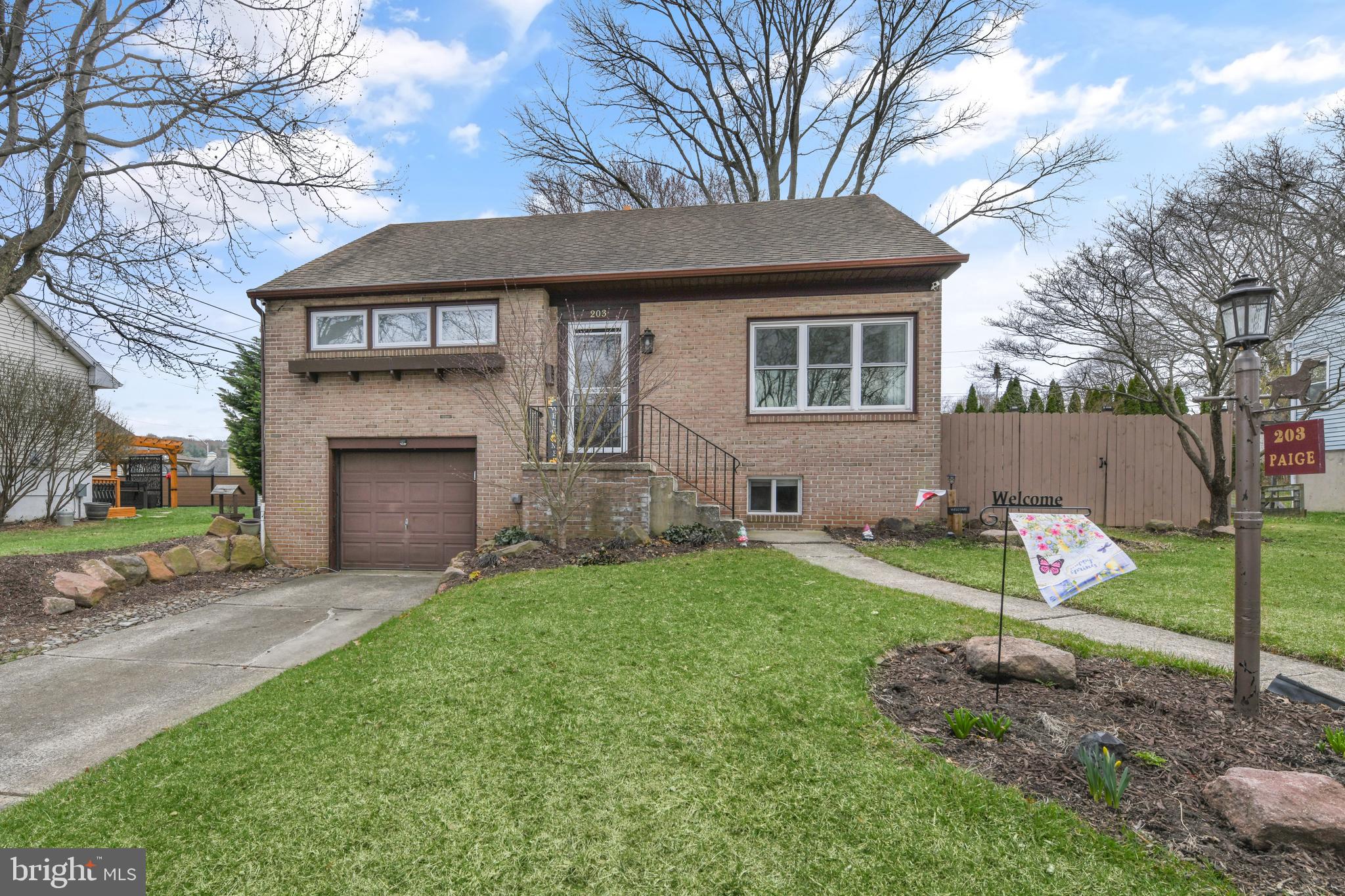 203 Eric Avenue Reading, PA 19607 - Photo 37 of 46 a front view of a house with a yard and trees